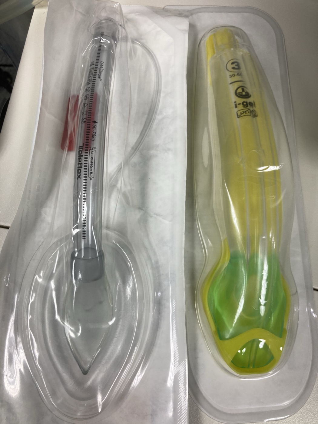 A classic laryngeal mask airway beside an i-gel supraglottic airway